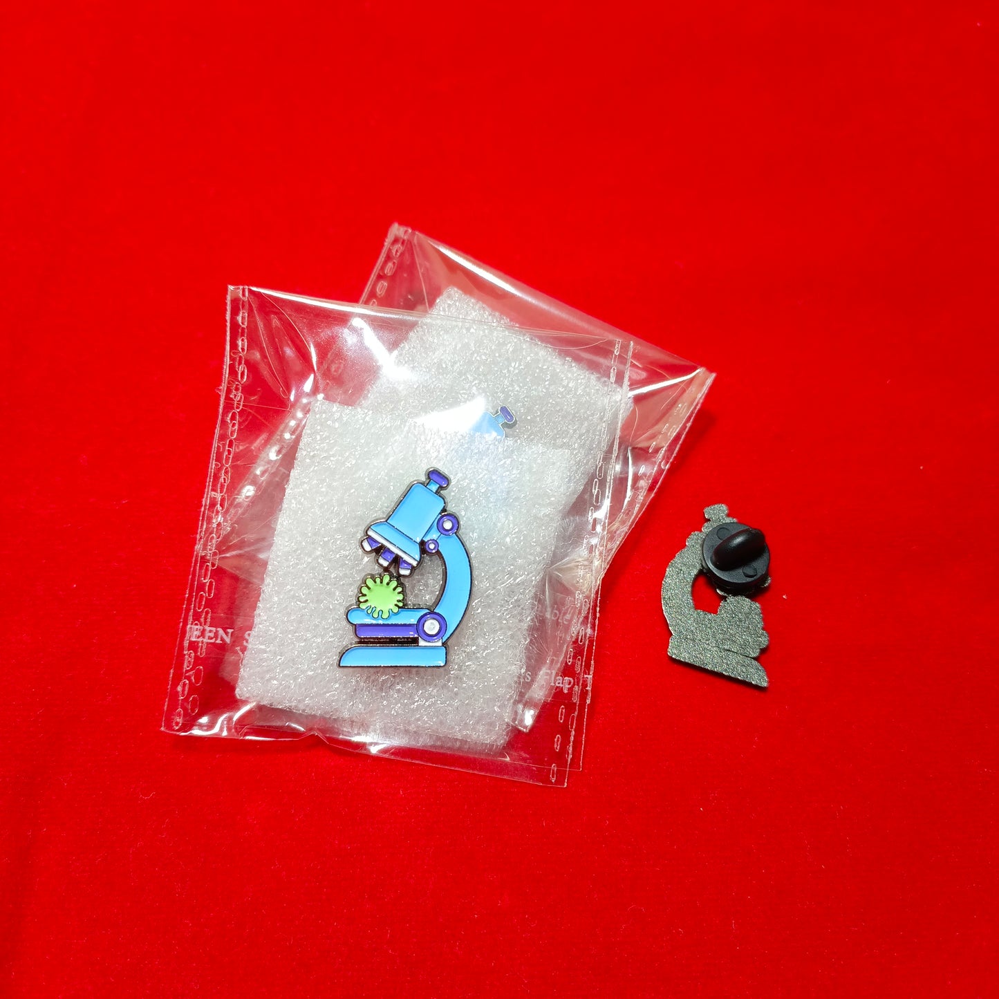 Lapel pins of microscope blue