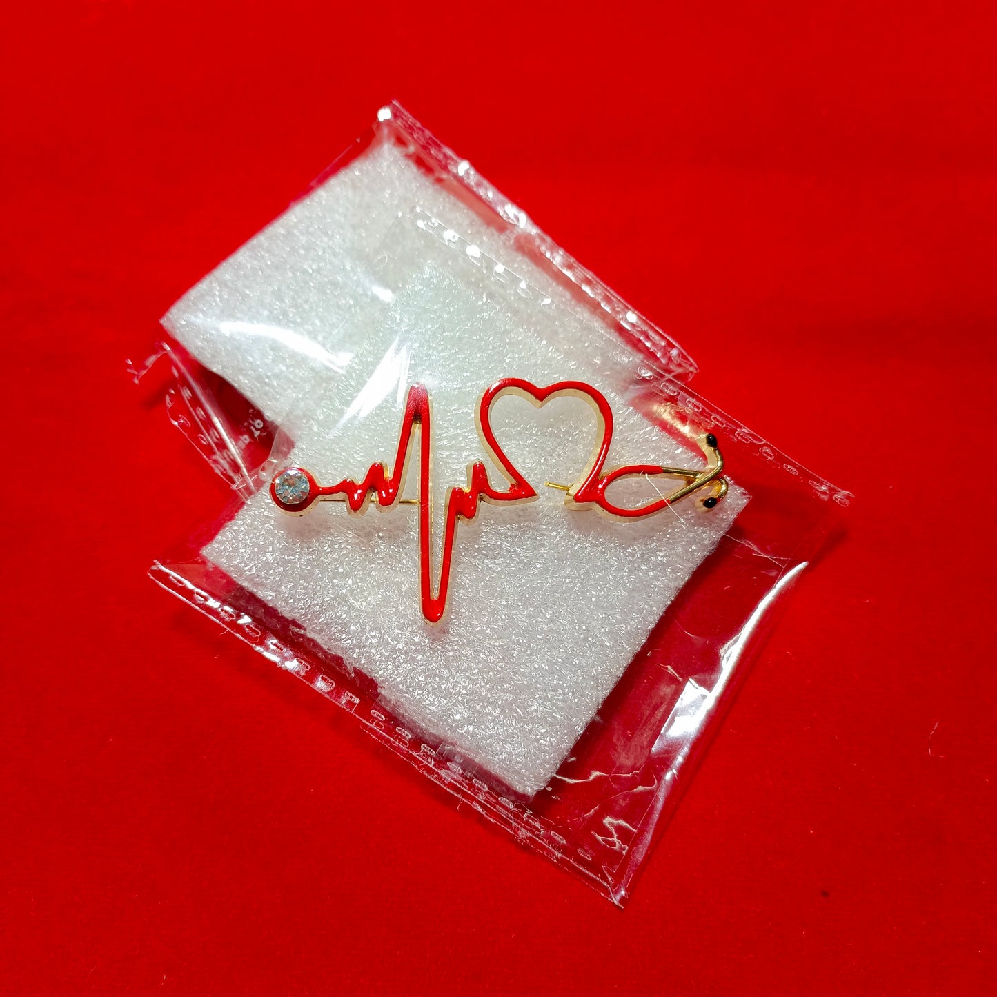 Lapel pins brooch of stethoscope in heart beats